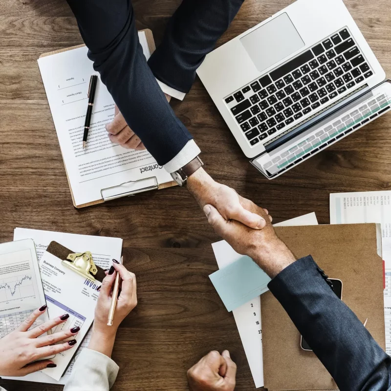 business-people-shaking-hands-together (1)-min business-people-shaking-hands-together (1)-min